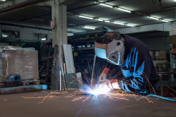 Person metal welding at Hayes Manufacturing.