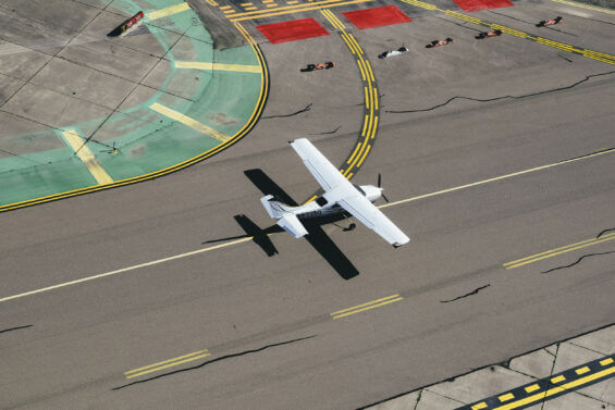 Modern small airplane on the asphalt airstrip.